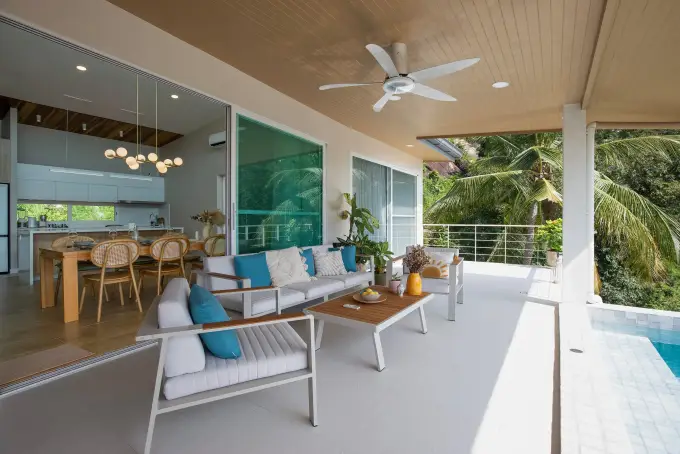 Covered terrace lounge opening into the villa